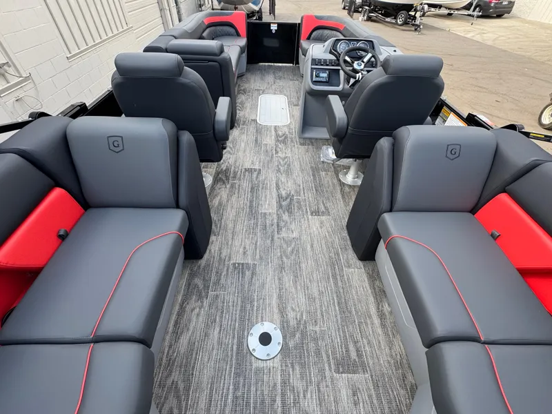 Slide: The Image of Interior of a modern pontoon boat with gray and red seating, steering wheel, and wood flooring. - 12