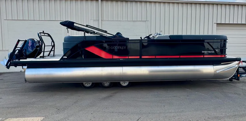 Slide: The Image of The image shows a modern pontoon boat by Godfrey, model SW 2286 SB, year 2025, on a trailer. - 1