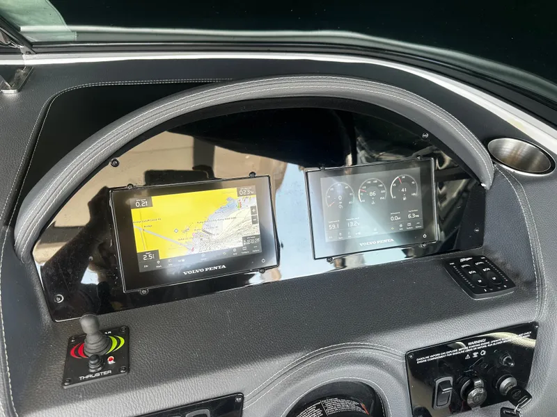 Slide: The Image of The dashboard of a 2023 Regal 2800 Bowrider with modern navigation and control displays. - 13