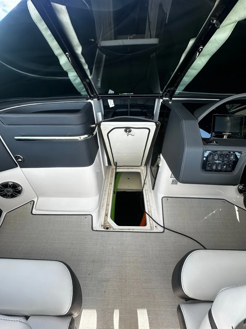 Slide: The Image of The image shows the interior of a 2023 Regal 2800 Bowrider with an open storage compartment. - 15