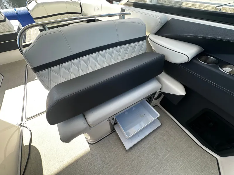 Slide: The Image of The interior of the 2023 Regal 2800 Bowrider features elegant seating with storage underneath. - 18