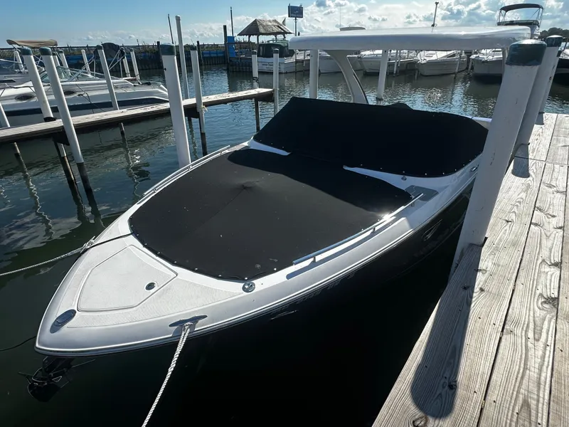 Slide: The Image of A 2023 Regal 2800 Bowrider docked, featuring a sleek design with a black cover. - 2