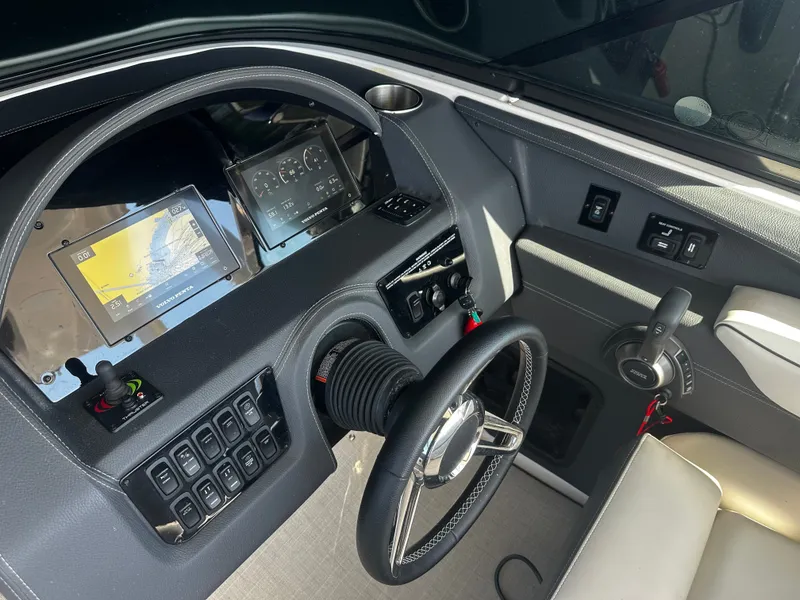 Slide: The Image of The image shows the cockpit of a 2023 Regal 2800 Bowrider with modern instruments and a sleek steering wheel. - 22