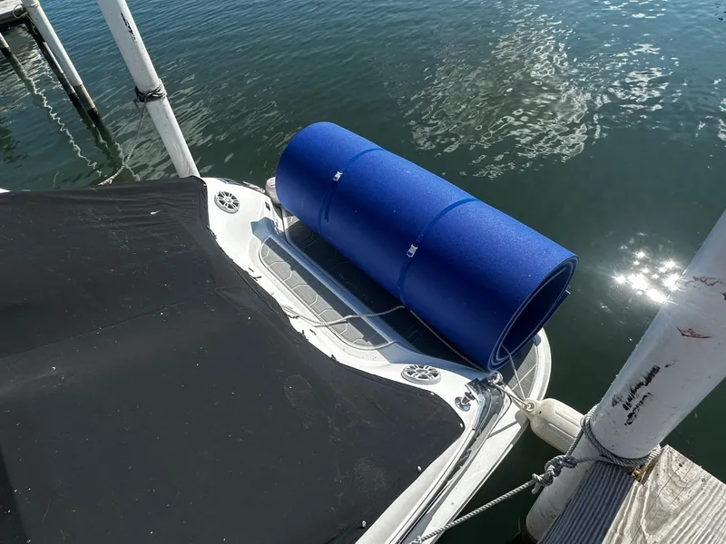 The Image of A 2023 Regal 2800 Bowrider is docked. A blue floatation device is placed on the stern. - 1