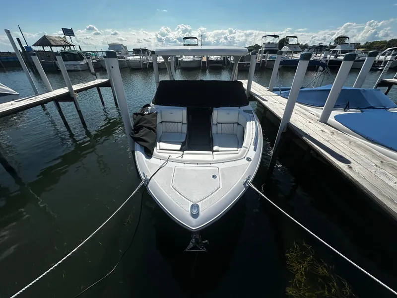 Slide: The Image of A 2023 Regal 2800 Bowrider docked. It features an open bow and is white. - 5