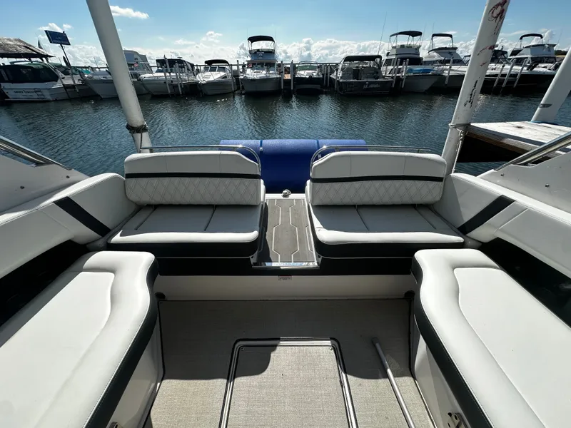 Slide: The Image of The image shows the cockpit of a Regal 2800 Bowrider with white upholstery, overlooking a marina. - 10