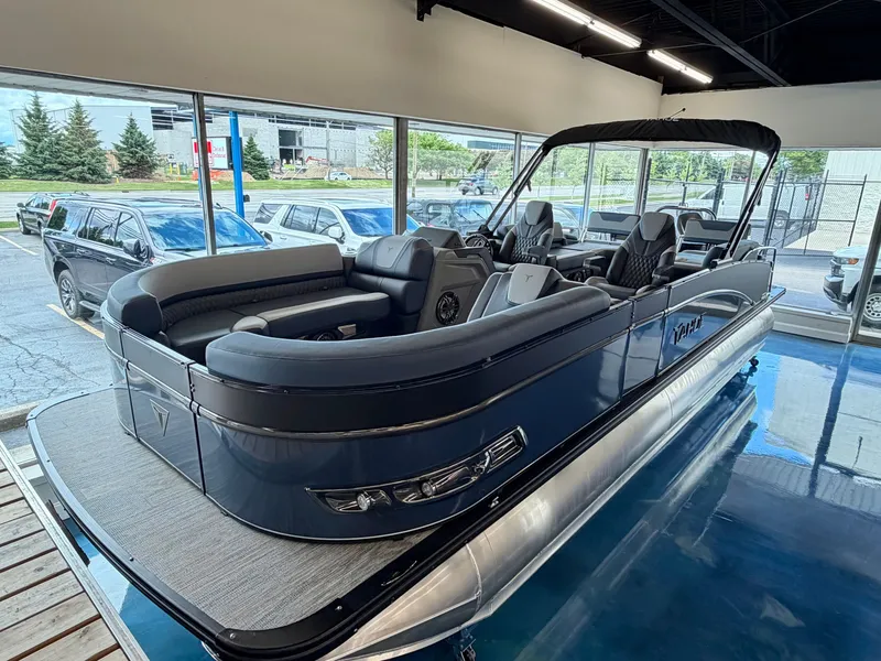 Slide: The Image of The image shows a modern pontoon boat in a showroom. It features sleek gray upholstery and a spacious deck. - 1