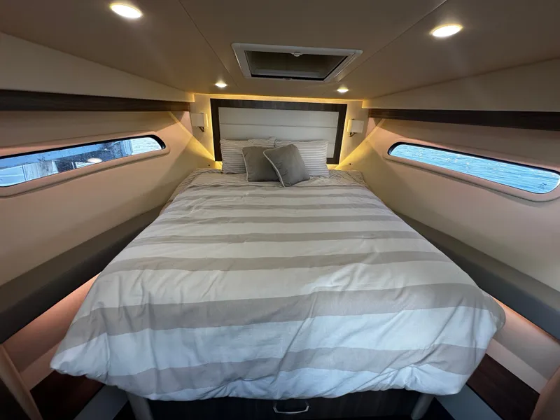 Slide: The Image of The image shows a cozy cabin with a large bed and windows on the sides. - 14