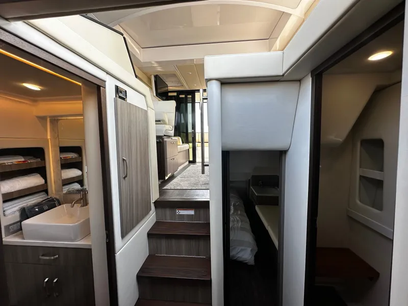 Slide: The Image of Interior of the 2022 Regal 38 Grande Coupe with stairs, cabins, and a sink. - 20