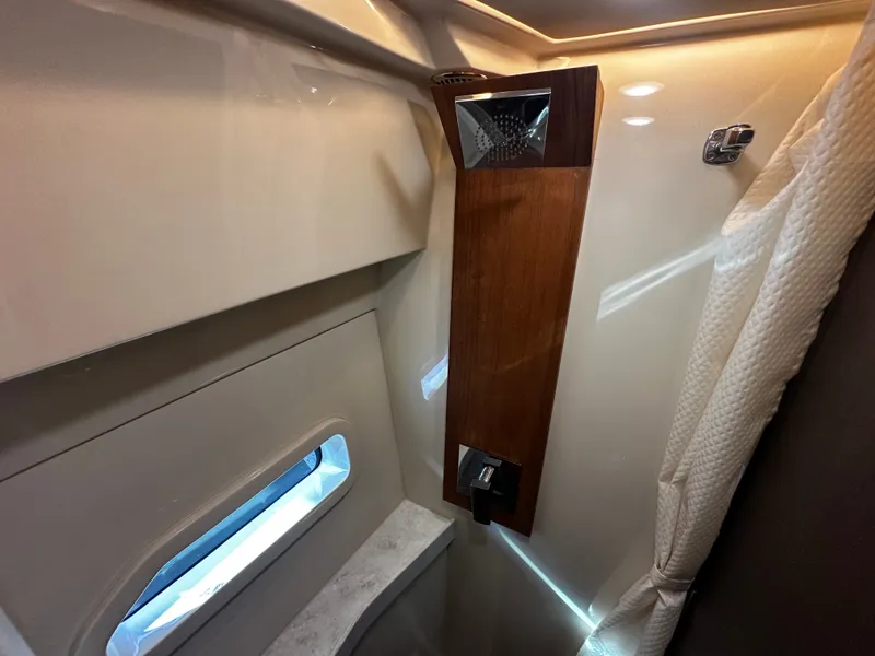 Slide: The Image of Interior of a 2022 Regal 38 Grande Coupe featuring a modern shower area and window. - 17