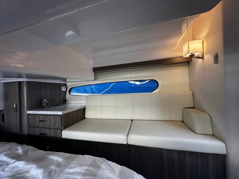 Slide: The Image of Interior of the 2022 Regal 38 Grande Coupe with a white sofa and window. - 18