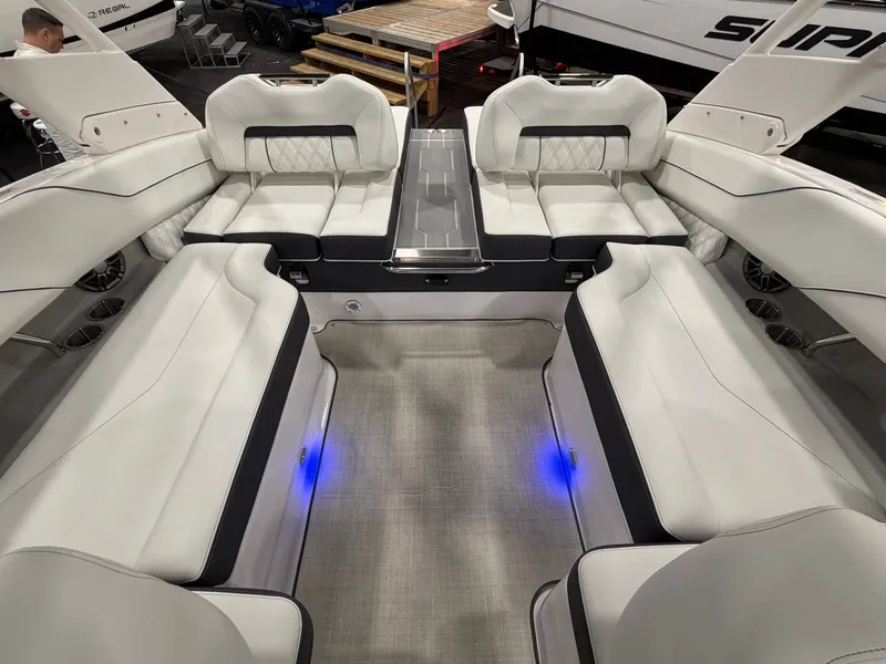 The Image of The image shows the interior of a 2026 Regal LS4 boat with luxurious white seating. - 1