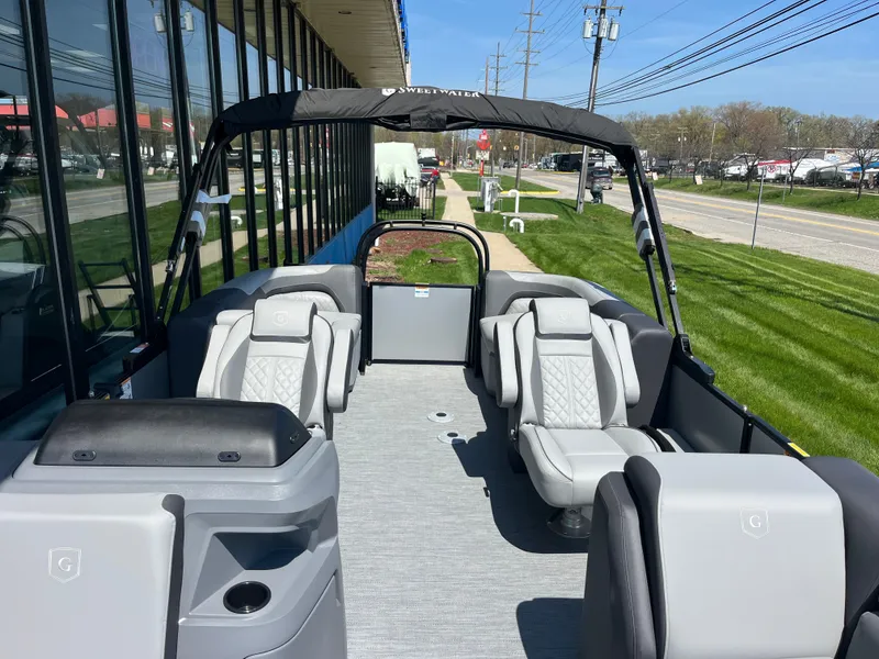 Slide: The Image of The image shows a modern pontoon boat with gray seating and a black sunshade. - 9
