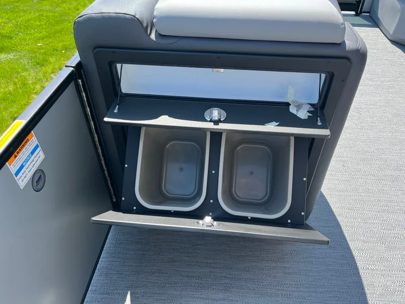 Slide: The Image of The image shows a storage compartment with two bins on a boat. - 3