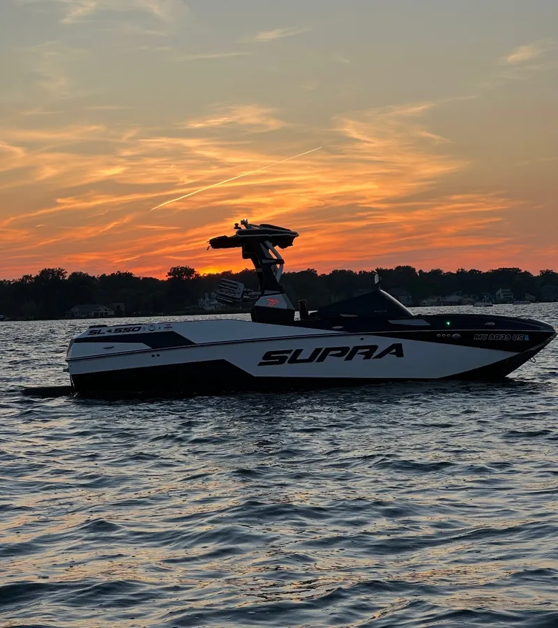 Slide: The Image of 2022 Supra SL 550 on the water at sunset. - 19
