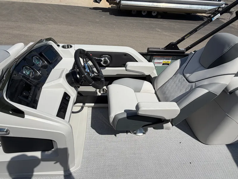 Slide: The Image of The image shows the helm of a modern boat with gray upholstered seats and a sleek dashboard. - 9