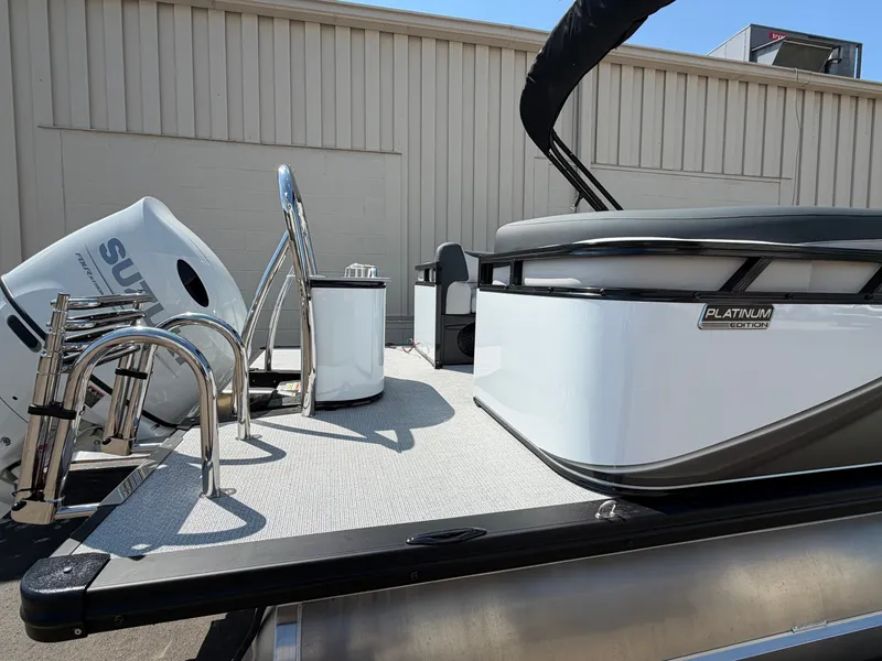 Slide: The Image of The image shows a modern pontoon boat with a Suzuki outboard motor and sleek stainless steel railings. - 4