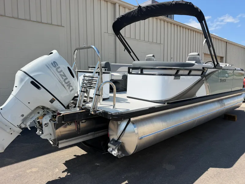 Slide: The Image of A modern pontoon boat with Suzuki outboard motor, silver hull, and black sunshade. - 3