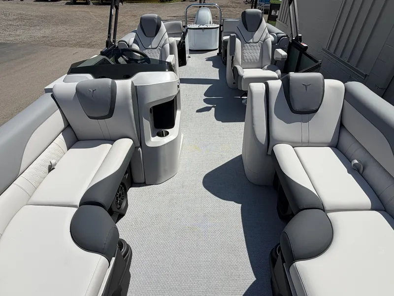 Slide: The Image of Interior of a modern pontoon boat with gray and white upholstery, multiple seating areas, and a helm station. - 5