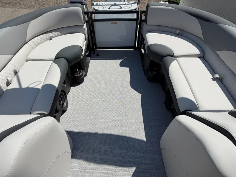 Slide: The Image of Interior view of a modern pontoon boat with gray upholstered seating and carpeted flooring. - 12