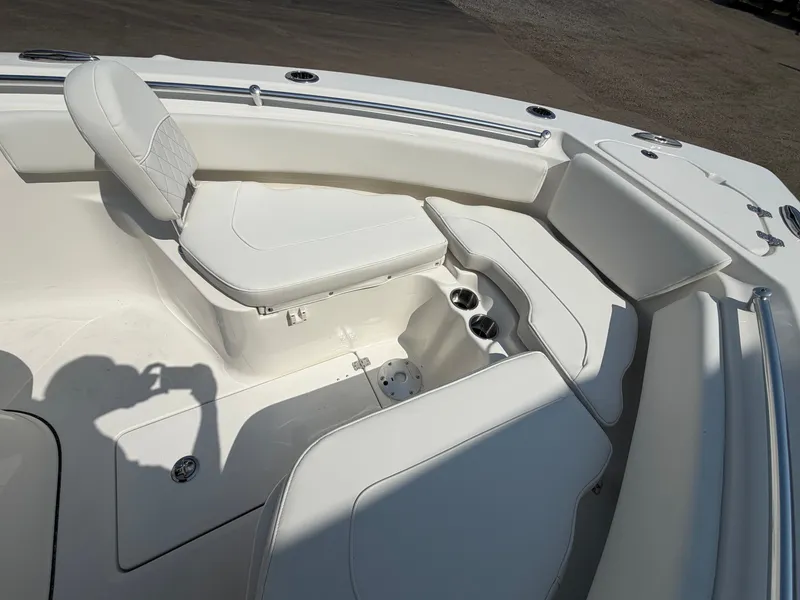 Slide: The Image of The image shows the bow area of a Key West 239 FS boat with white seating and cup holders. - 5