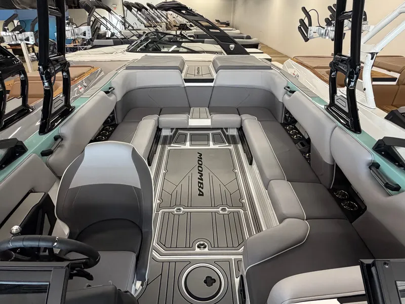 Slide: The Image of The image shows the interior of a 2026 Moomba Tykon boat with gray upholstery. - 26