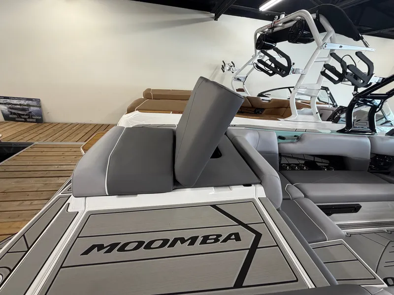 Slide: The Image of The image shows the rear of a Moomba Tykon boat with gray upholstery and a modern design. - 21