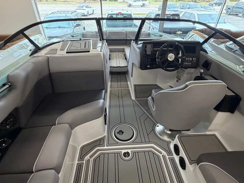 Slide: The Image of The image shows the cockpit of a 2026 Moomba Tykon boat with gray upholstery and a modern helm. - 15