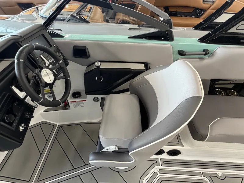 Slide: The Image of The image shows the cockpit of a 2026 Moomba Tykon with a modern steering wheel and gray seat. - 24