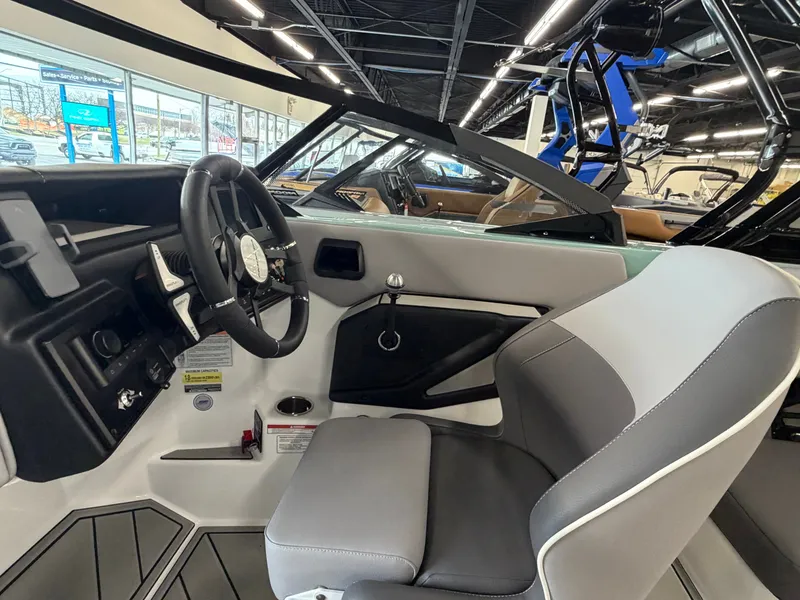 Slide: The Image of The image shows the cockpit of a 2026 Moomba Tykon with a modern steering wheel and gray seats. - 19