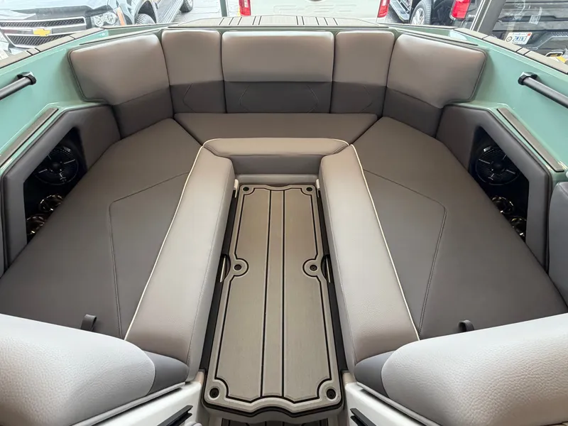 Slide: The Image of The image shows the interior of a 2026 Moomba Tykon boat with gray upholstery. - 18