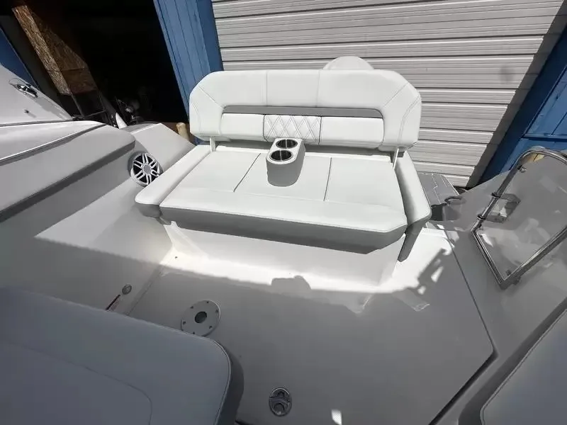 Slide: The Image of The image shows a white bench seat with cup holders on a boat. - 16
