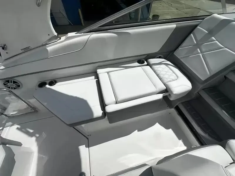Slide: The Image of Interior of a 2027 Regal 26 XO boat with white cushioned seats and cup holders. - 17
