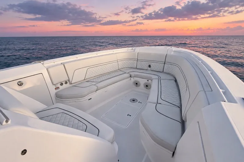 Slide: The Image of Luxurious seating on 2020 Intrepid 345 Nomad SE boat at sunset over the ocean. - 32