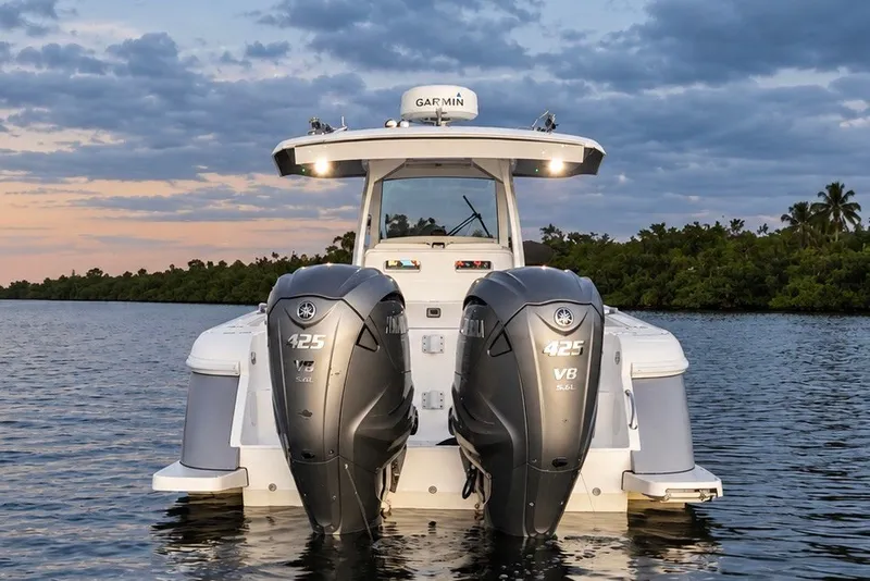 Slide: The Image of 2020 Intrepid 345 Nomad SE boat with dual Yamaha 425 V8 engines on water. - 27