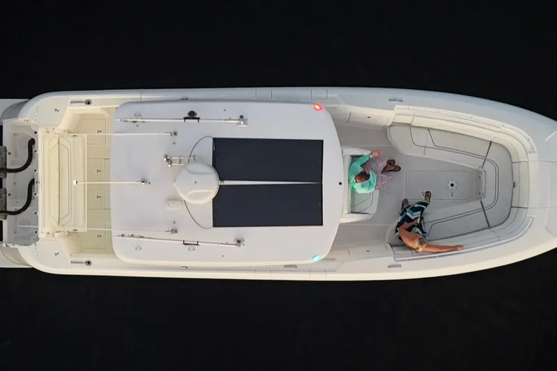 Slide: The Image of Overhead view of 2020 Intrepid 345 Nomad SE boat with two people on deck. - 23