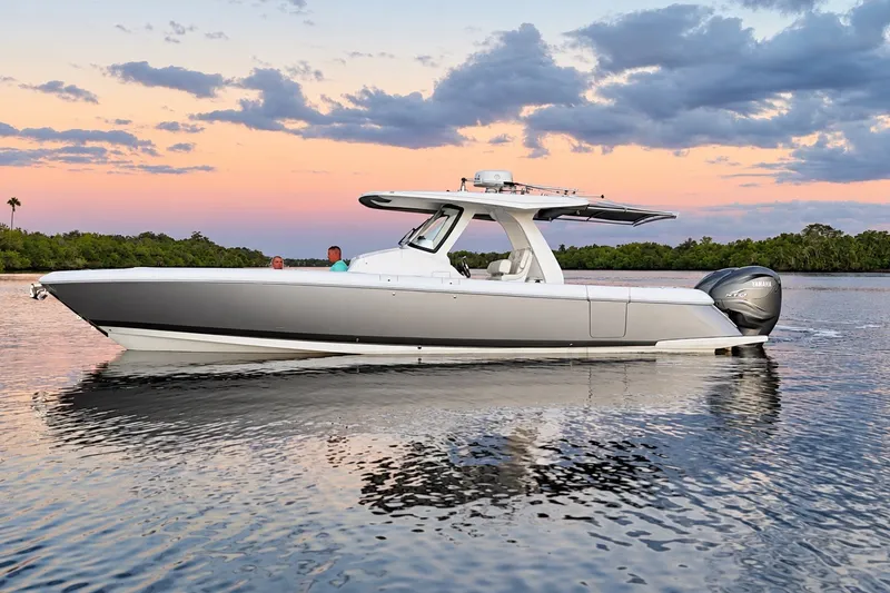 The Image of 2020 Intrepid 345 Nomad SE boat cruising at sunset on calm waters. - 0