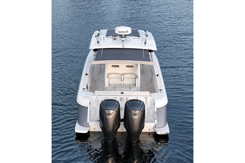 Slide: The Image of 2020 Intrepid 345 Nomad SE boat with twin 425 engines on calm water. - 26