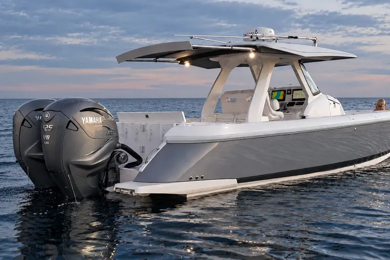 Slide: The Image of 2020 Intrepid 345 Nomad SE boat with Yamaha engines on calm water. - 10