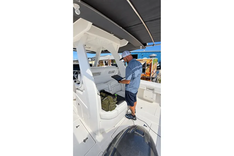 Slide: The Image of Man inspecting 2020 Intrepid 345 Nomad SE boat interior. - 47