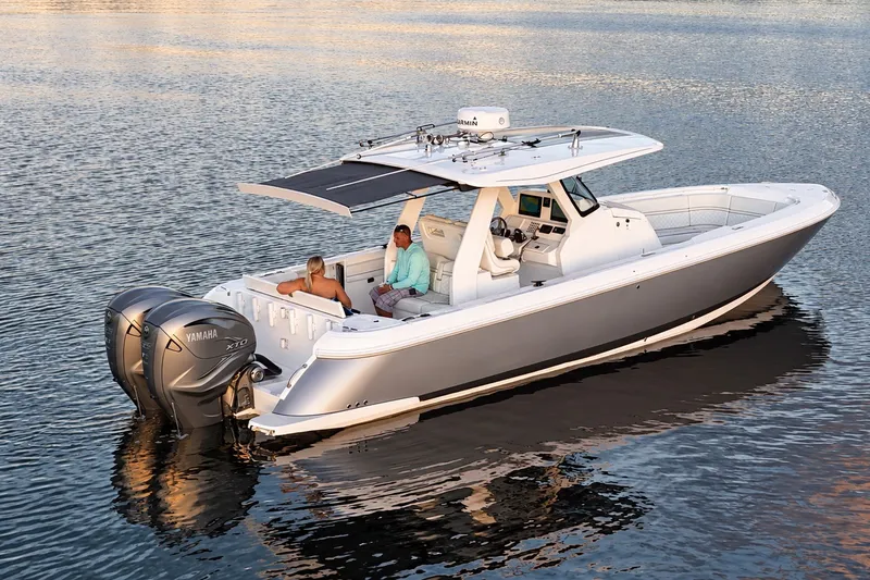 Slide: The Image of 2020 Intrepid 345 Nomad SE boat on calm water, featuring dual Yamaha engines. - 15