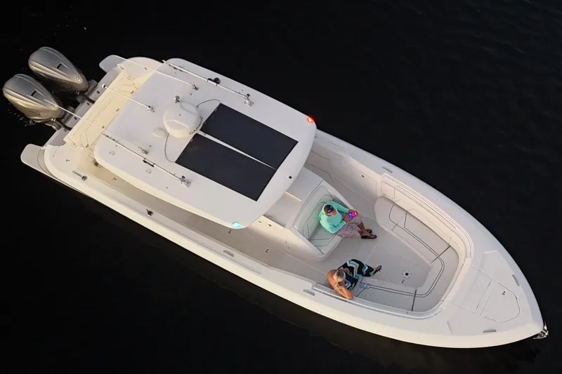 Slide: The Image of Aerial view of 2020 Intrepid 345 Nomad SE boat with two people onboard. - 24