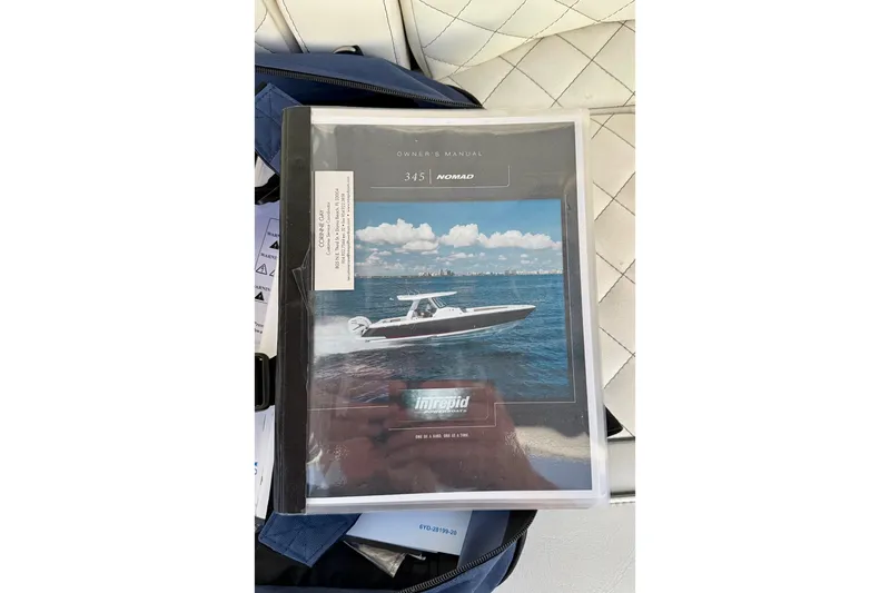 Slide: The Image of Owner's manual for 2020 Intrepid 345 Nomad SE boat on a white seat. - 42