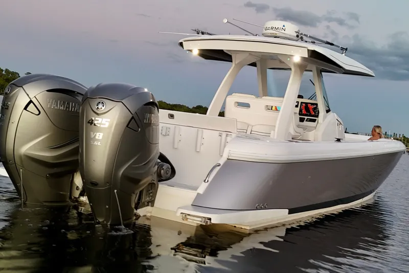 Slide: The Image of 2020 Intrepid 345 Nomad SE boat with Yamaha V8 engines on calm water. - 12