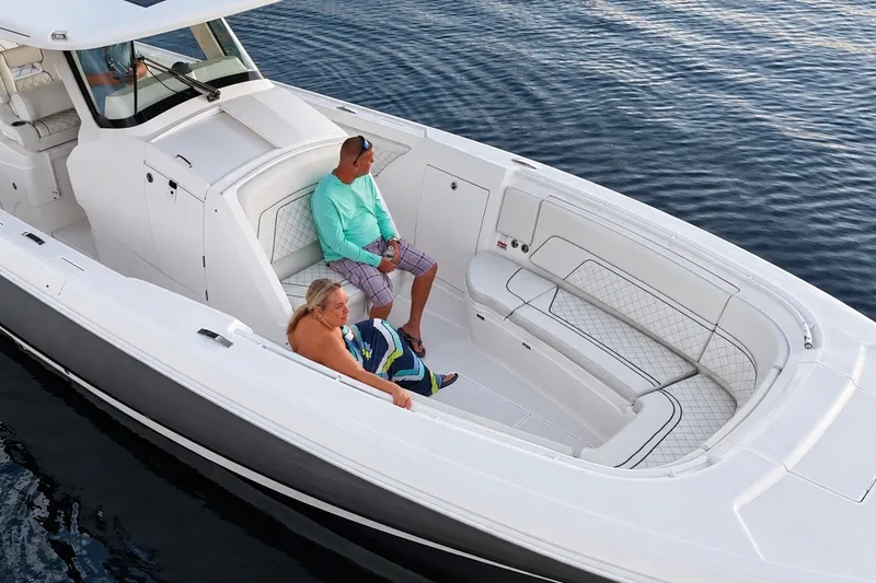 Slide: The Image of 2020 Intrepid 345 Nomad SE boat with passengers relaxing on deck. - 30
