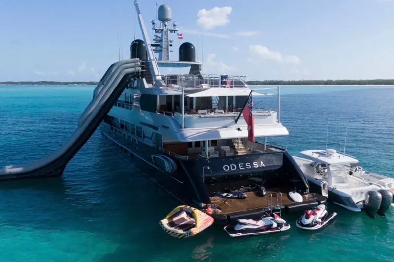 Slide: The Image of Luxurious yacht with slide, jet skis, and Intrepid 345 Nomad SE boat in turquoise waters. - 45