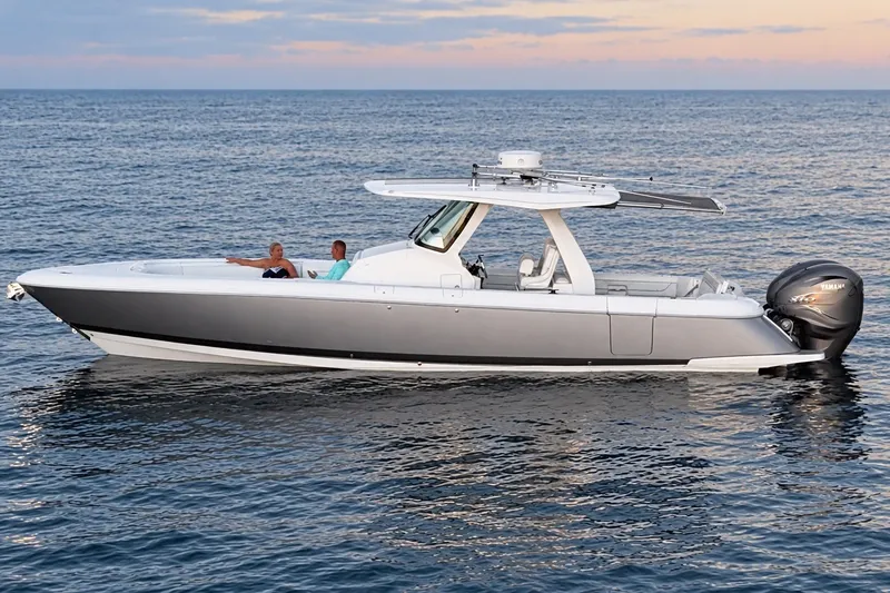Slide: The Image of 2020 Intrepid 345 Nomad SE boat cruising on calm ocean waters at sunset. - 9