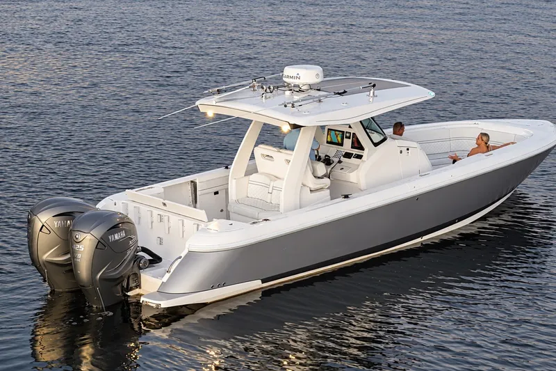 Slide: The Image of 2020 Intrepid 345 Nomad SE boat on water with dual Yamaha engines. - 7