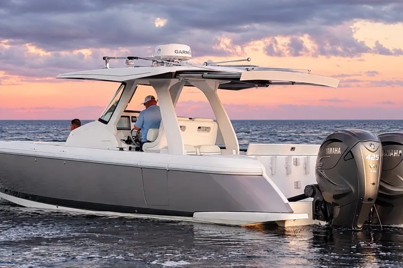 Slide: The Image of Intrepid 345 Nomad SE 2020 boat on water at sunset with Yamaha engines. - 3