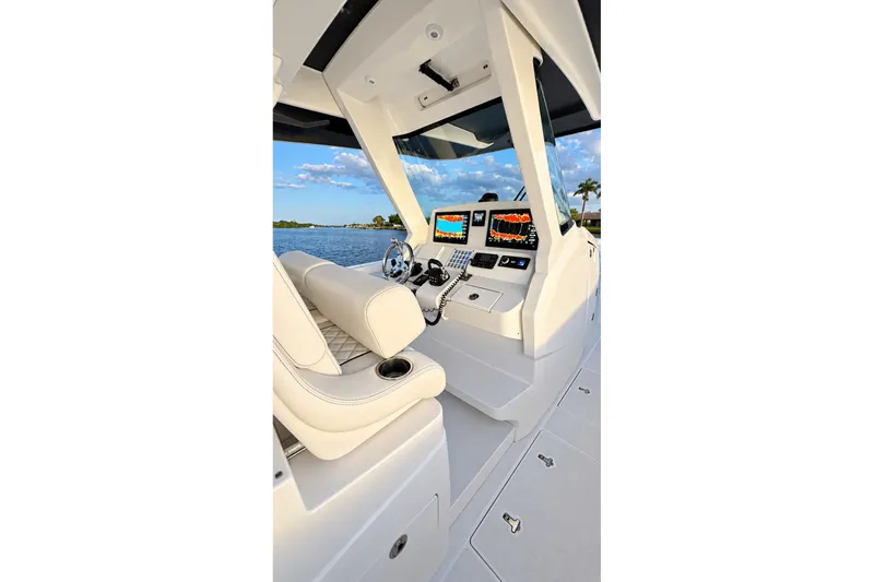Slide: The Image of 2020 Intrepid 345 Nomad SE boat cockpit with modern navigation displays and luxurious seating. - 34